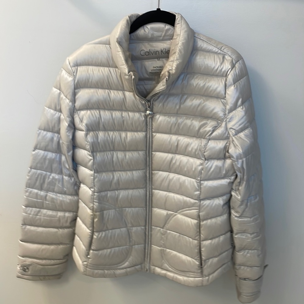 Women’s Calvin Klein light grey packable puffer jacket.  Size medium.